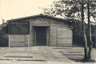 Townley Rd Baptist Chapel before exterior brick surface added on. Note how some of the grave stones from the previous site have been inlaid at the large frontage